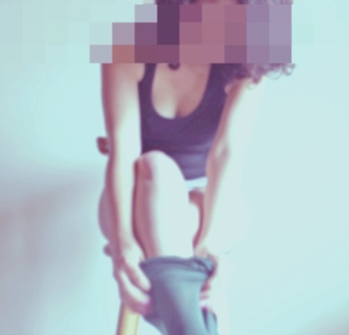 Fig. 11 Partially pixelated photograph of a woman on a chair putting on her stockings.
