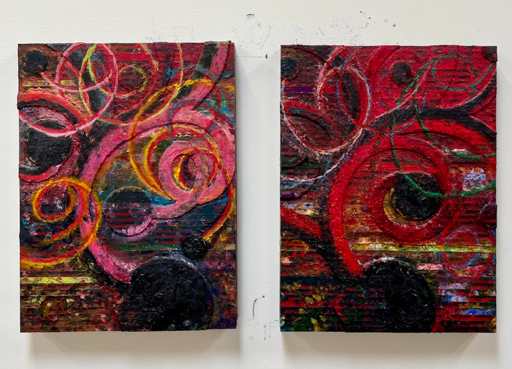 Two canvases, spiraling circles of red and black.