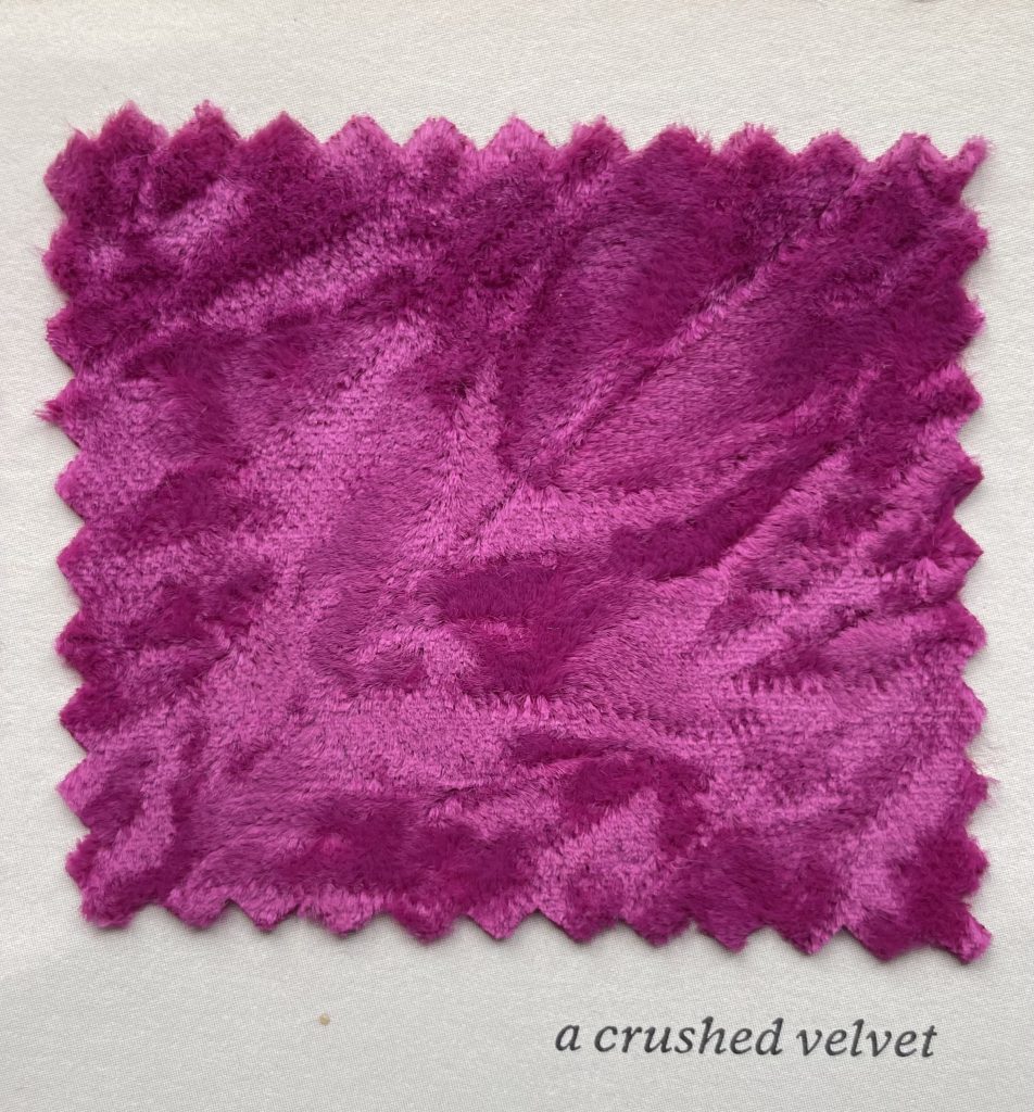 A square of purple crushed velvet, with jagged edges.
